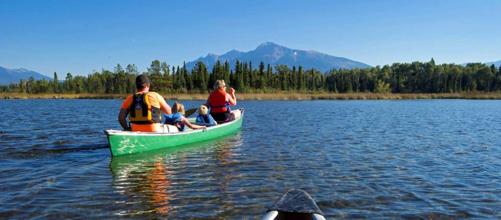 Family in canoe on lake
