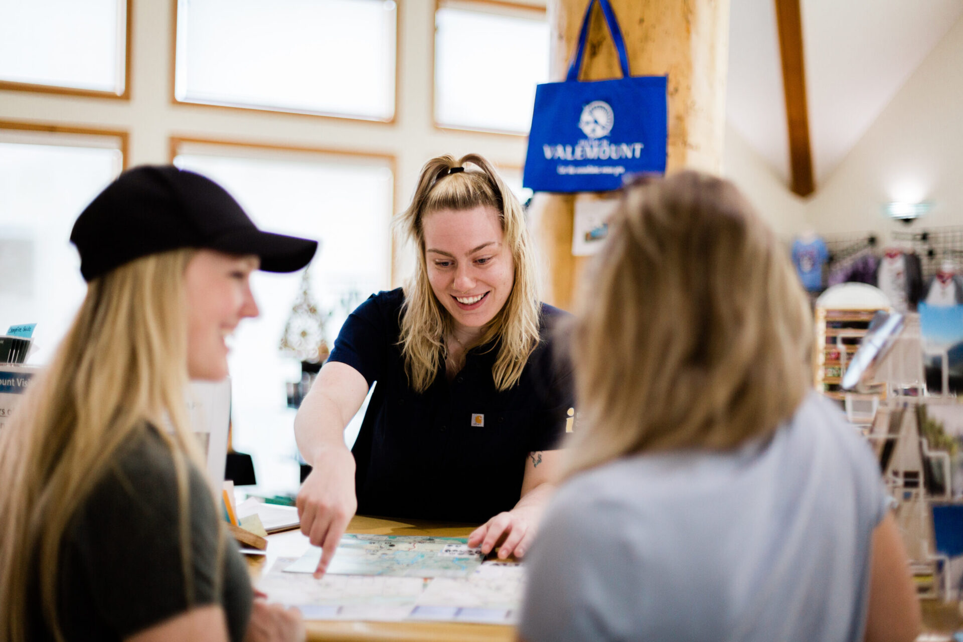 Two women getting information from staff at the Valemount Visitor Information Centre.
